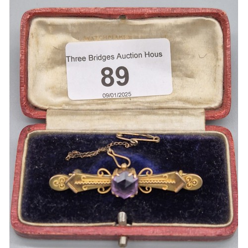 89 - 9ct yellow gold bar brooch fitted with a hexagonal cut Amethyst gem stone. [4grams]