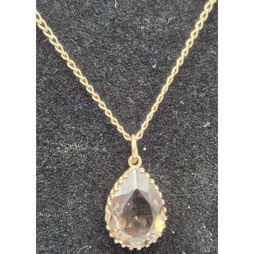 79 - 9ct yellow gold and Smokey quartz pendant together with a 9ct yellow gold chain. [3.49Grams]