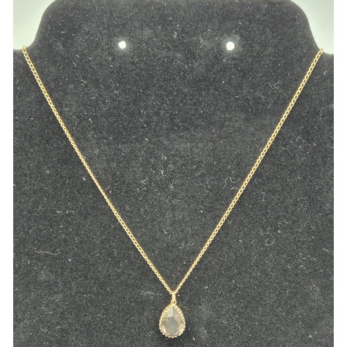 79 - 9ct yellow gold and Smokey quartz pendant together with a 9ct yellow gold chain. [3.49Grams]