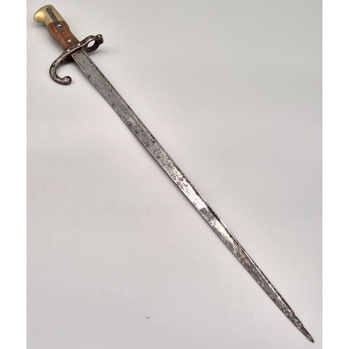 101 - 1881 French Bayonet. Showing various markings and engraved to the side of the blade. Brass and wood ... 