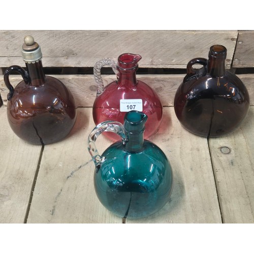 107 - A Collection of four antique and vintage glass flagon Decanters; Cranberry glass Decanter, Two Amber... 