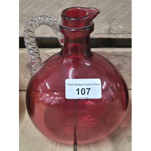 107 - A Collection of four antique and vintage glass flagon Decanters; Cranberry glass Decanter, Two Amber... 