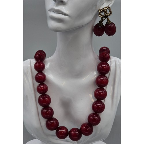 91 - Vintage Cherry amber coloured graduating bead necklace with a pair of matching earrings.