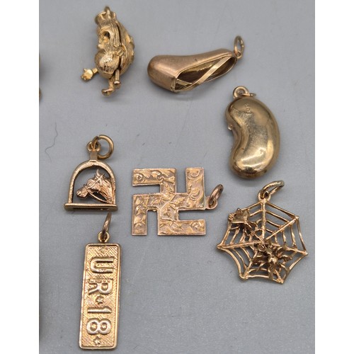 64 - 10 various 9ct yellow gold charms; Ballet shoes, spider web, Jelley bean, fan and various others. [1... 