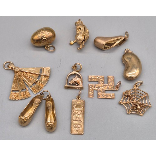 64 - 10 various 9ct yellow gold charms; Ballet shoes, spider web, Jelley bean, fan and various others. [1... 