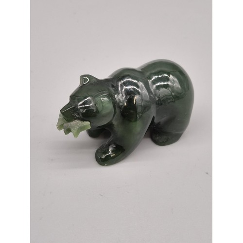 73 - Hand carved jade sculpture of a bear holding a fish in its mouth. [5cm length]