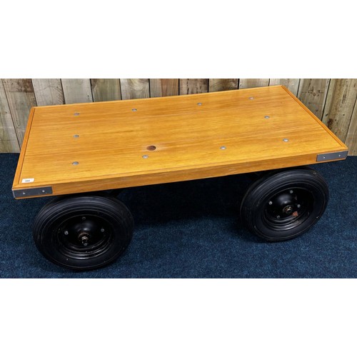 300 - Contemporary bespoke made coffee table. Solid light oak top raised on metal frame and four wheels. 4... 