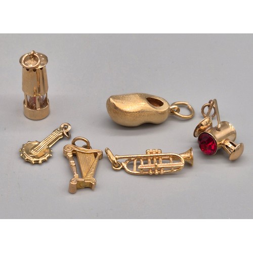 58 - A Collection of eight 9ct yellow gold charms. Sailing boats, Galleon, Rickshaw and car. 14.06grams.