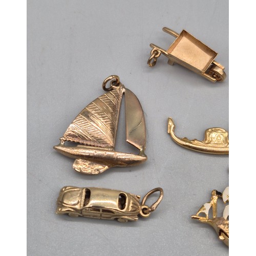 58 - A Collection of eight 9ct yellow gold charms. Sailing boats, Galleon, Rickshaw and car. 14.06grams.