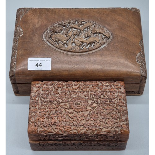 44 - Two Indian carved wooden boxes containing mixed jewellery. Brooches, Necklaces and many more items.