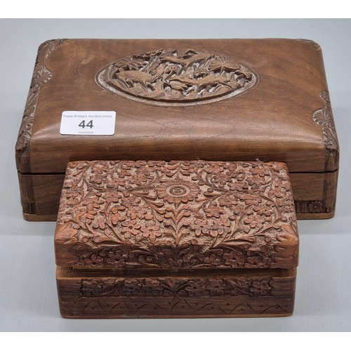 44 - Two Indian carved wooden boxes containing mixed jewellery. Brooches, Necklaces and many more items.