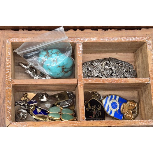 44 - Two Indian carved wooden boxes containing mixed jewellery. Brooches, Necklaces and many more items.