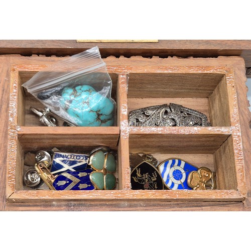 44 - Two Indian carved wooden boxes containing mixed jewellery. Brooches, Necklaces and many more items.