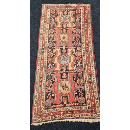 497 - Large Iranian hand knotted rug. Red ground. 285x131cm.