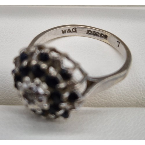 20 - 9ct white gold, sapphire and diamond cluster ring. 3.91Grams. Ring size O.