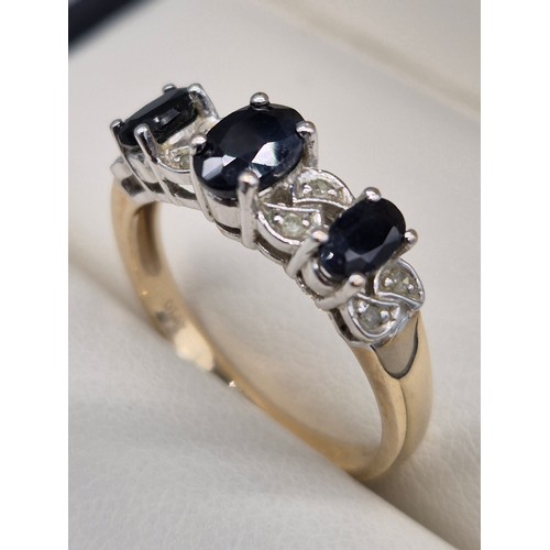 25 - 9ct yellow gold Sapphire and Diamond stone ring. Three oval cut sapphires and eight small round cut ... 