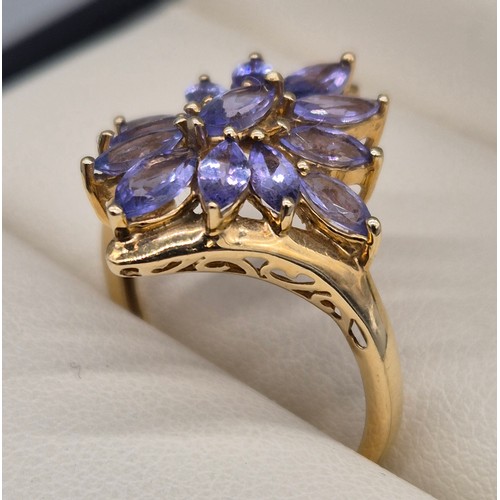 23 - 9ct yellow gold and blue/ purple tourmaline gem stone ring in the shape of a flower. 3.13grams. Ring... 