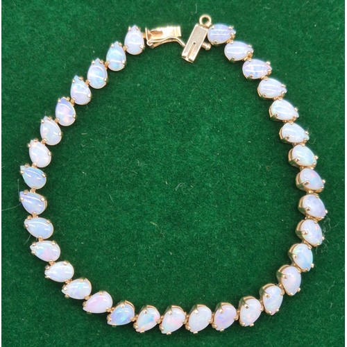 5 - 9ct yellow gold and opal stone bracelet. 33 tear drop cut opals. 18cm length. 7grams.