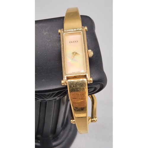 29 - Vintage 1996 Gucci 1500 ladies bangle watch. Mother of pearl dial. Gold plated. Comes with Gucci car... 