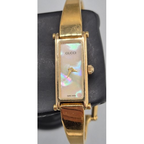 29 - Vintage 1996 Gucci 1500 ladies bangle watch. Mother of pearl dial. Gold plated. Comes with Gucci car... 