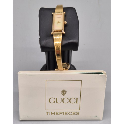29 - Vintage 1996 Gucci 1500 ladies bangle watch. Mother of pearl dial. Gold plated. Comes with Gucci car... 
