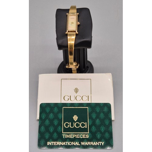 29 - Vintage 1996 Gucci 1500 ladies bangle watch. Mother of pearl dial. Gold plated. Comes with Gucci car... 