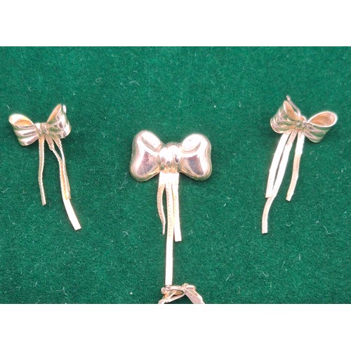 39 - A Lot of 9ct yellow gold jewellery design with ribbon design. Brooch, earrings, chains and pendants.... 