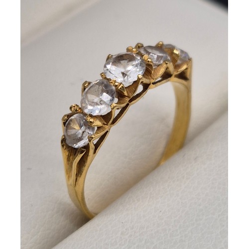 51 - 14ct yellow gold ladies ring fitted with five round cut white Sapphire gem stones. 2.24grams.