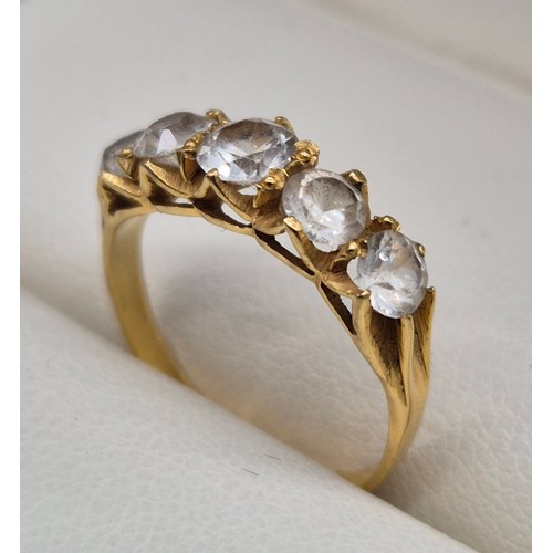 51 - 14ct yellow gold ladies ring fitted with five round cut white Sapphire gem stones. 2.24grams.