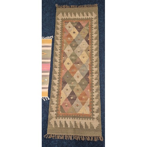 278 - Hand knotted kilim runner rug in a green ground and three smaller hand made rugs. Runner- 200x70cm