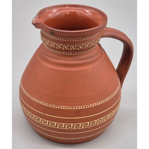 279 - 19th century Wedgwood terracotta water jug. Having a Greek key band design. 14.5cm high.