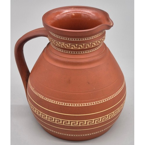 279 - 19th century Wedgwood terracotta water jug. Having a Greek key band design. 14.5cm high.