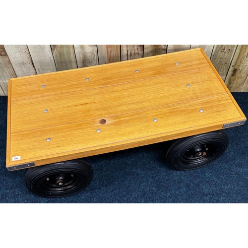 300 - Contemporary bespoke made coffee table. Solid light oak top raised on metal frame and four wheels. 4... 