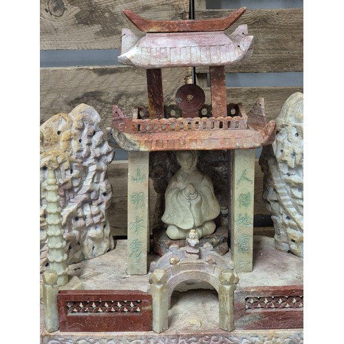 316 - Large antique Chinese soapstone temple carving. Raised on a wooden base. Buddha praying sat to the i... 