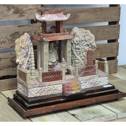 316 - Large antique Chinese soapstone temple carving. Raised on a wooden base. Buddha praying sat to the i... 