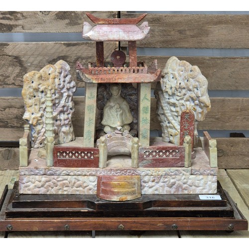 316 - Large antique Chinese soapstone temple carving. Raised on a wooden base. Buddha praying sat to the i... 