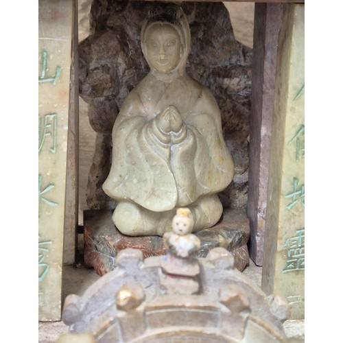 316 - Large antique Chinese soapstone temple carving. Raised on a wooden base. Buddha praying sat to the i... 