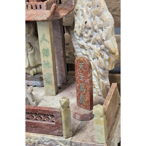 316 - Large antique Chinese soapstone temple carving. Raised on a wooden base. Buddha praying sat to the i... 