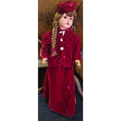 655 - Large German Victorian doll with stand. Having a red velvet dress. Having movable limbs and eyes. 80... 