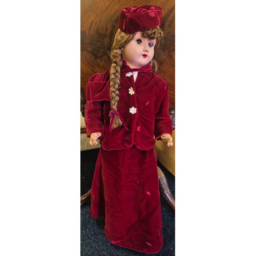 655 - Large German Victorian doll with stand. Having a red velvet dress. Having movable limbs and eyes. 80... 
