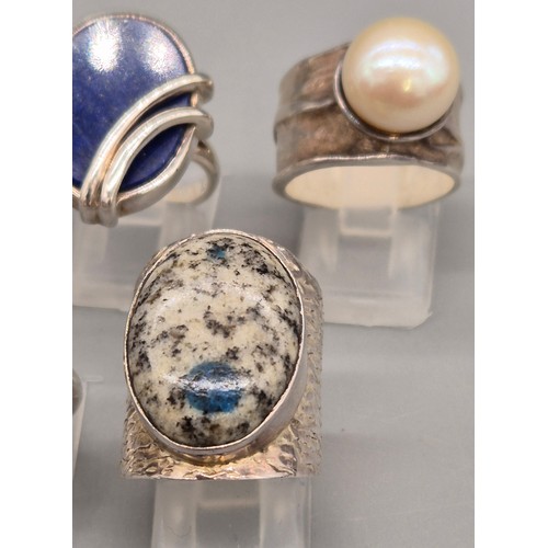 69 - A Collection of seven Silver and gem stone rings; Amber, Lapis Lazuli, Agate, Pearl and quartz stone... 