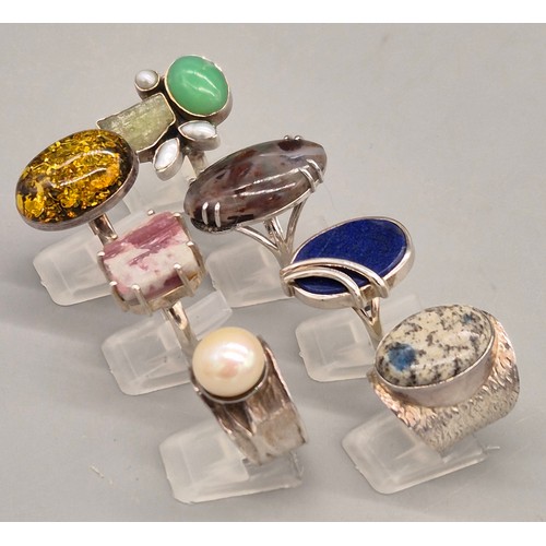 69 - A Collection of seven Silver and gem stone rings; Amber, Lapis Lazuli, Agate, Pearl and quartz stone... 