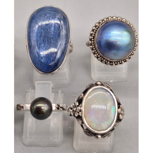 71 - A Collection of 10 Silver and Gem stone rings; Black pearl, Green hardstone, Opal and floral design,... 