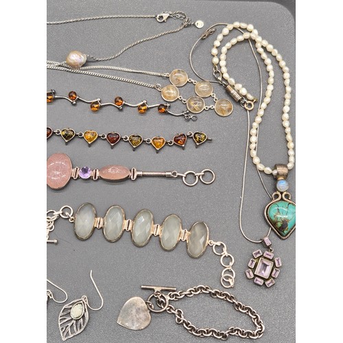 76 - A collection of silver jewellery; Silver and amber bracelets. Silver bracelet with t- bar and heart ... 