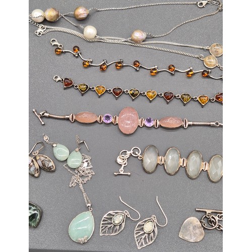 76 - A collection of silver jewellery; Silver and amber bracelets. Silver bracelet with t- bar and heart ... 