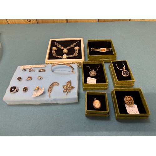 103A - A tray of silver and costume jewellery; Various Art Deco silver rings. Silver bangle. Silver and mar... 