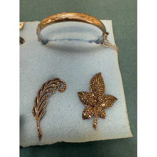 103A - A tray of silver and costume jewellery; Various Art Deco silver rings. Silver bangle. Silver and mar... 