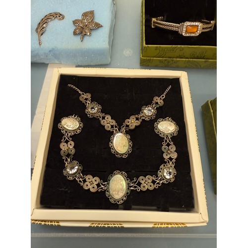 103A - A tray of silver and costume jewellery; Various Art Deco silver rings. Silver bangle. Silver and mar... 