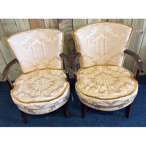 246 - Pair of vintage bedroom arm chairs. Gilt trim upholstery. Raised on shaped legs.