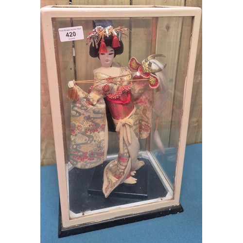 Cased Japanese Geisha figure. Fitted within a glass and wood cabinet.